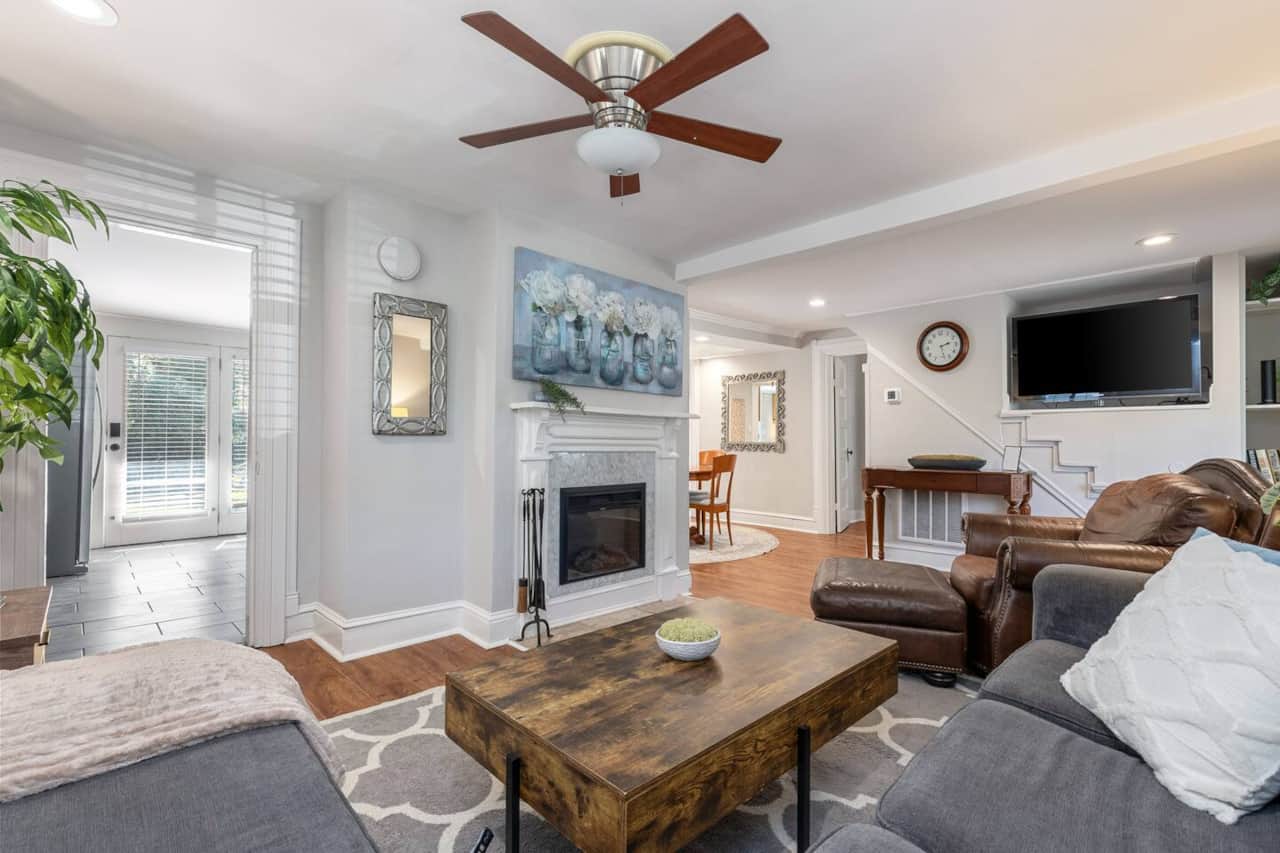 Living room with electric fireplace, ceiling fan and Roku TV