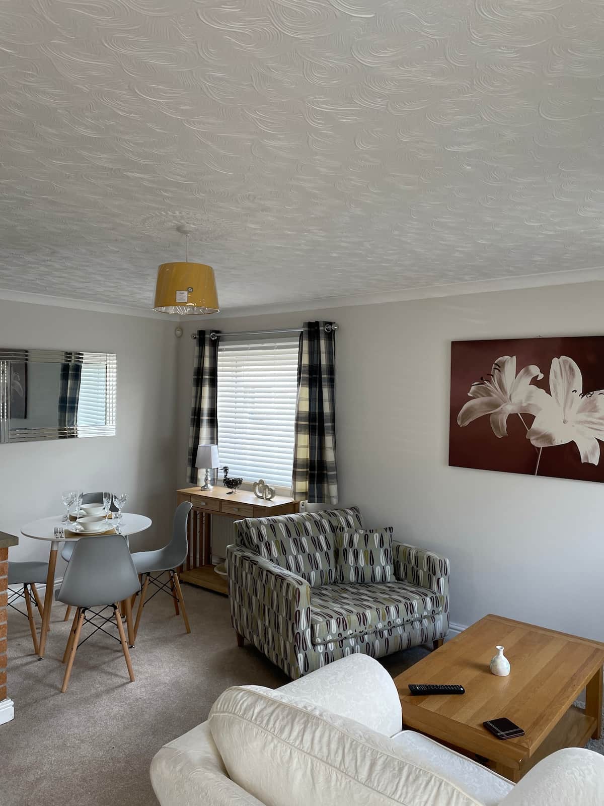 Living/dining area with snuggle couch and armchair 