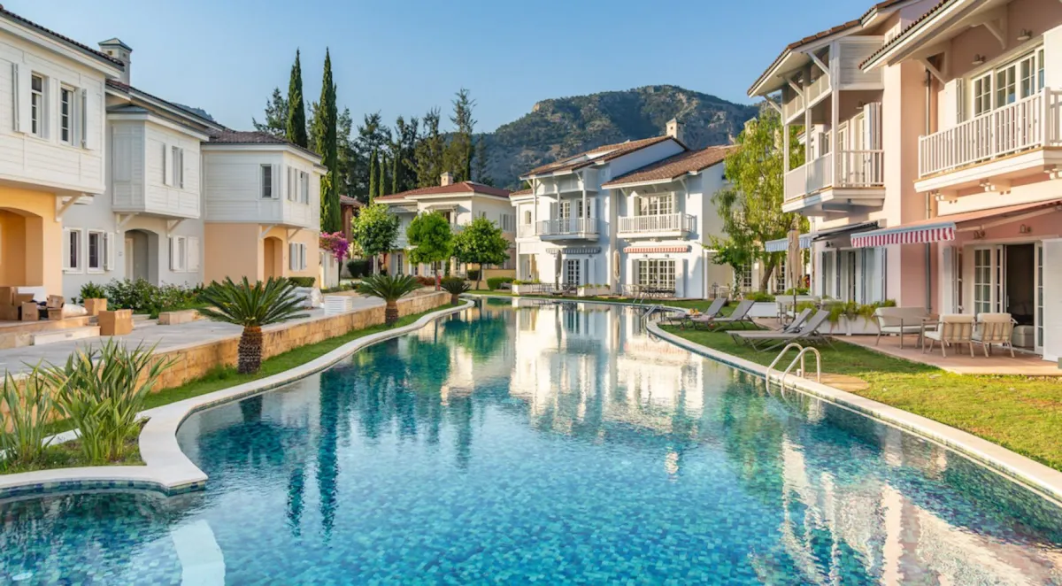 Swimming pool surrounded by villas and greenery, Portville B2 044, Gocek