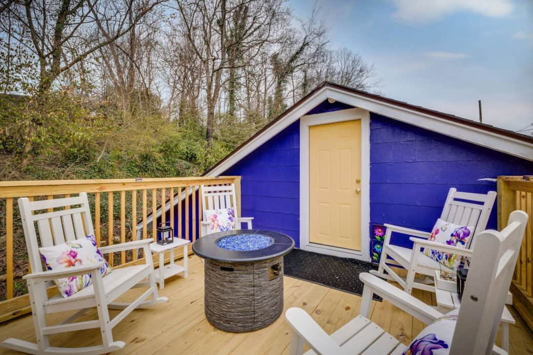 The upstairs deck is a quiet spot to sit and unwind. Rockers, pillows, and a fire table.