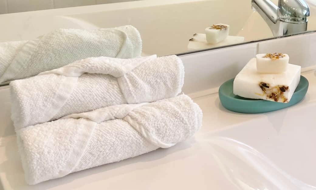 Fresh white towels and toiletries set out for guests