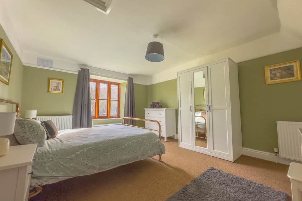 Master bedroom with kingsize bed, dressing table, wardrobe and chest of drawers