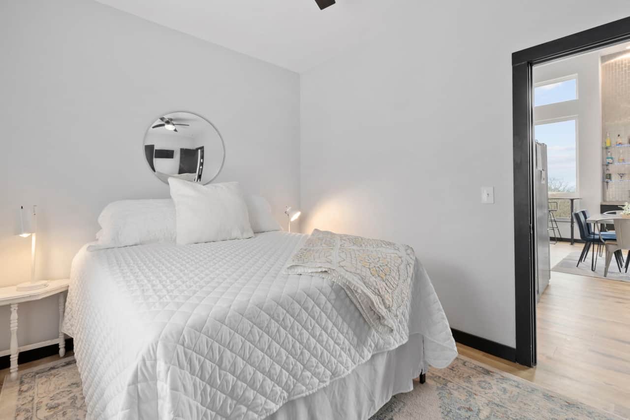 Queen bedroom with TV and walk-in closet