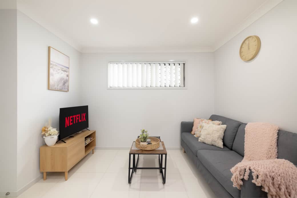 Living Area: Bright living space with comfortable seating and TV 