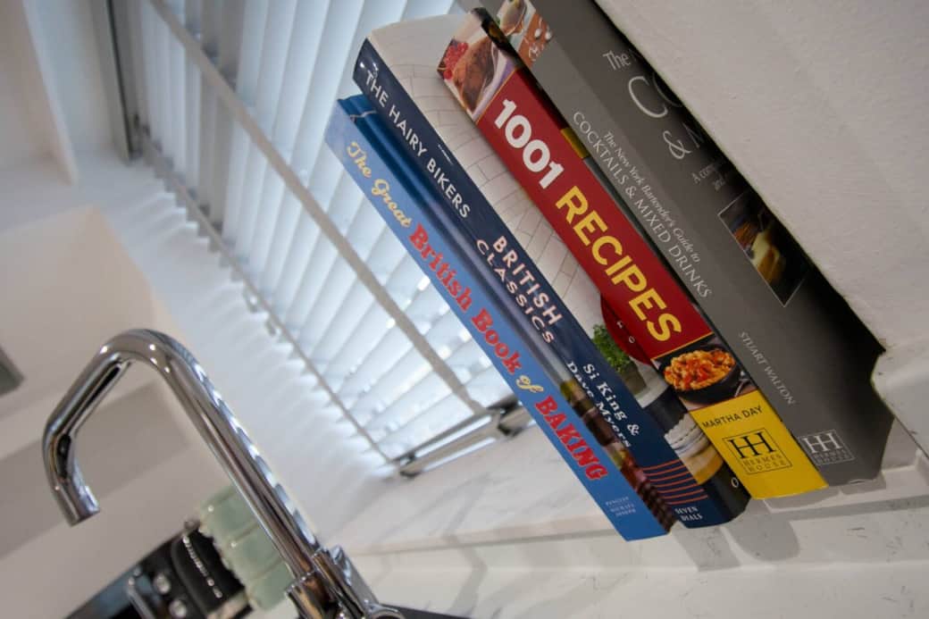 A handpicked shelf of cookbooks in the kitchen and ideal for guests who fancy baking, trying out British classics, or mixing up a cocktail or two.