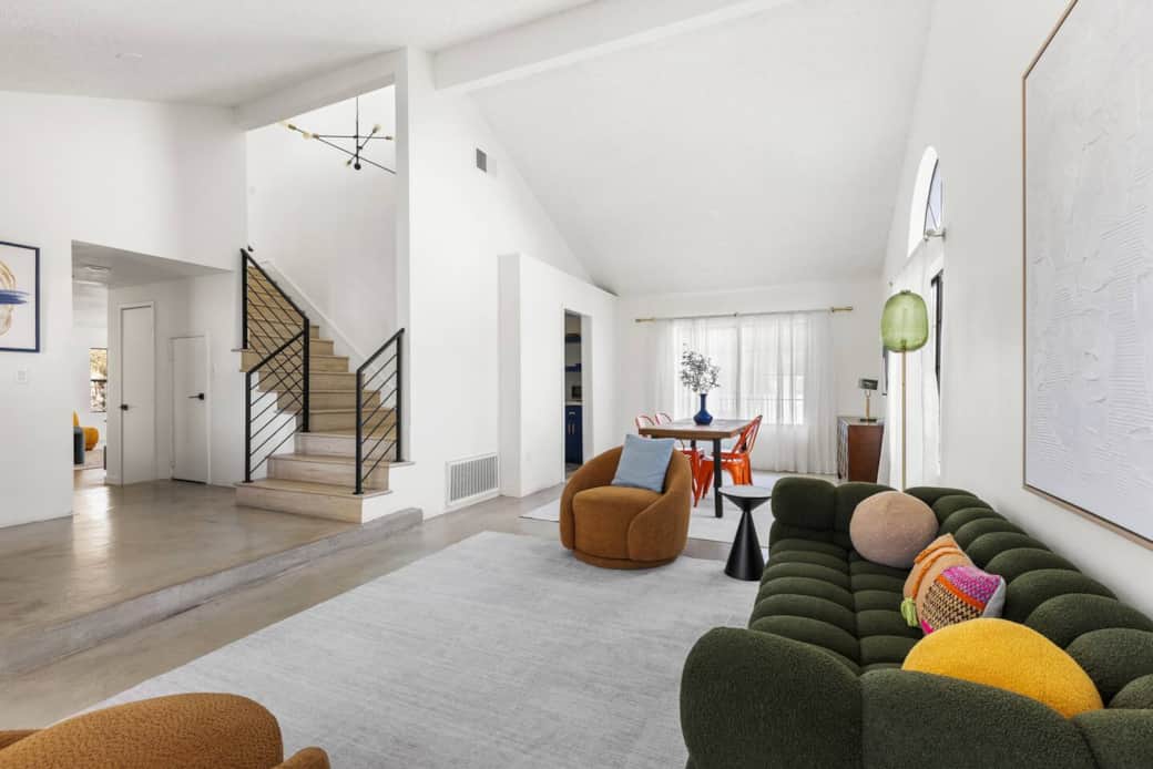 Open floor plan connects living, dining, and stairs for a bright, airy feel for easy socializing.