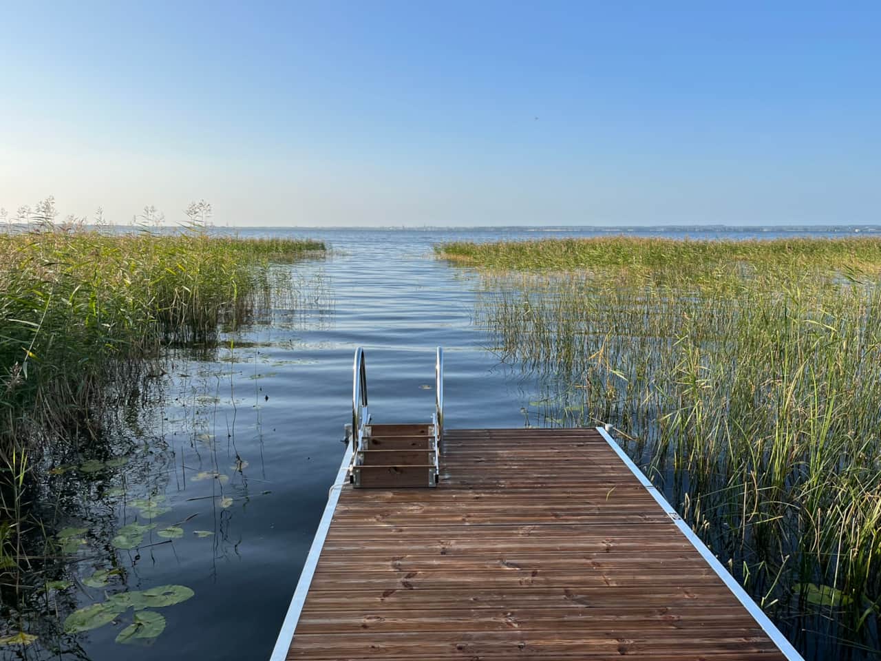 Pier with rowing boat and bathing
