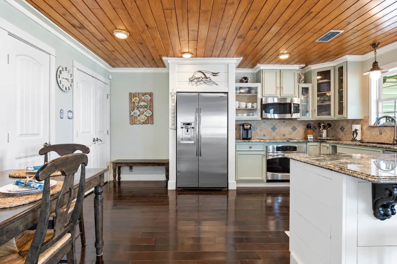 Fully stocked kitchen with island seating and stainless-steel appliances