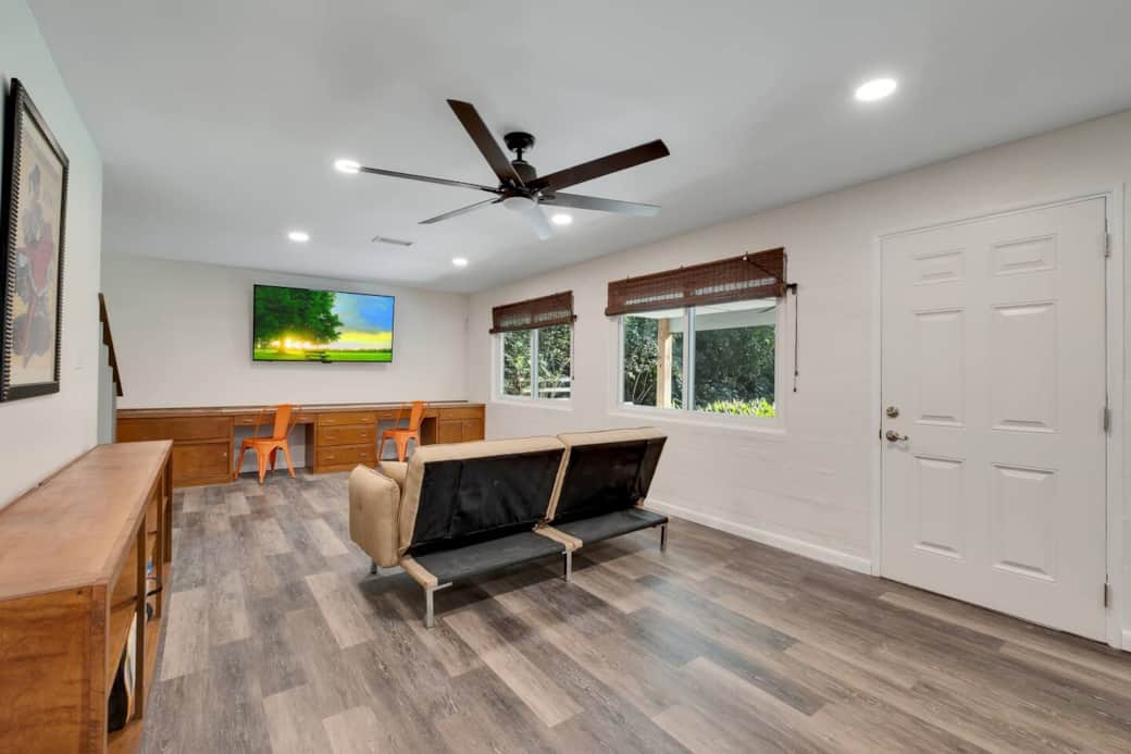 Renovated basement with large workspace, 70" TV, 2 futons for lounging, access to patio and backyard. Lots of natural light from 3 oversized windows.