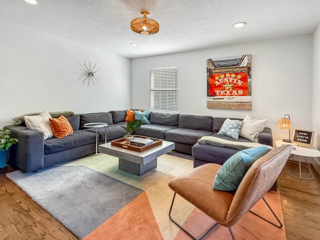 Expansive sectional, vibrant art, and midcentury touches set the stage for your Austin getaway. Expansive sectional, vibrant art, and midcentury touches set the stage for your Austin getaway.