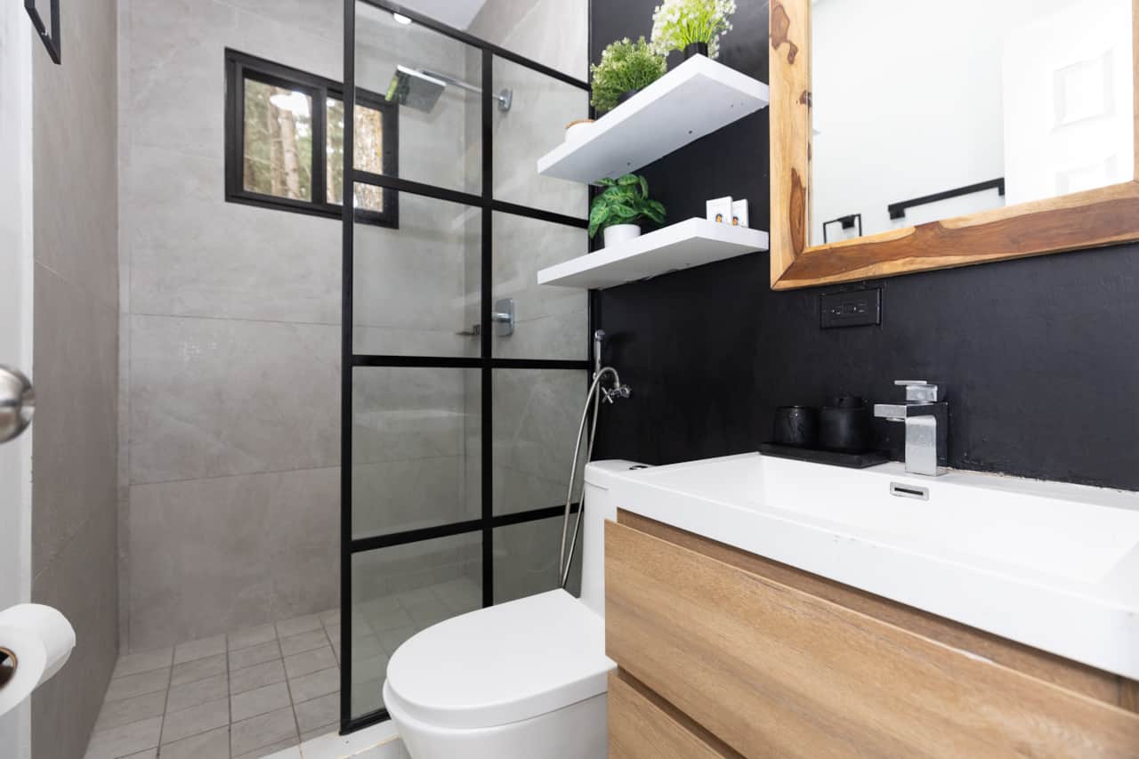 A sleek glass shower adds modern luxury to this eco friendly vacation rental in Panama.