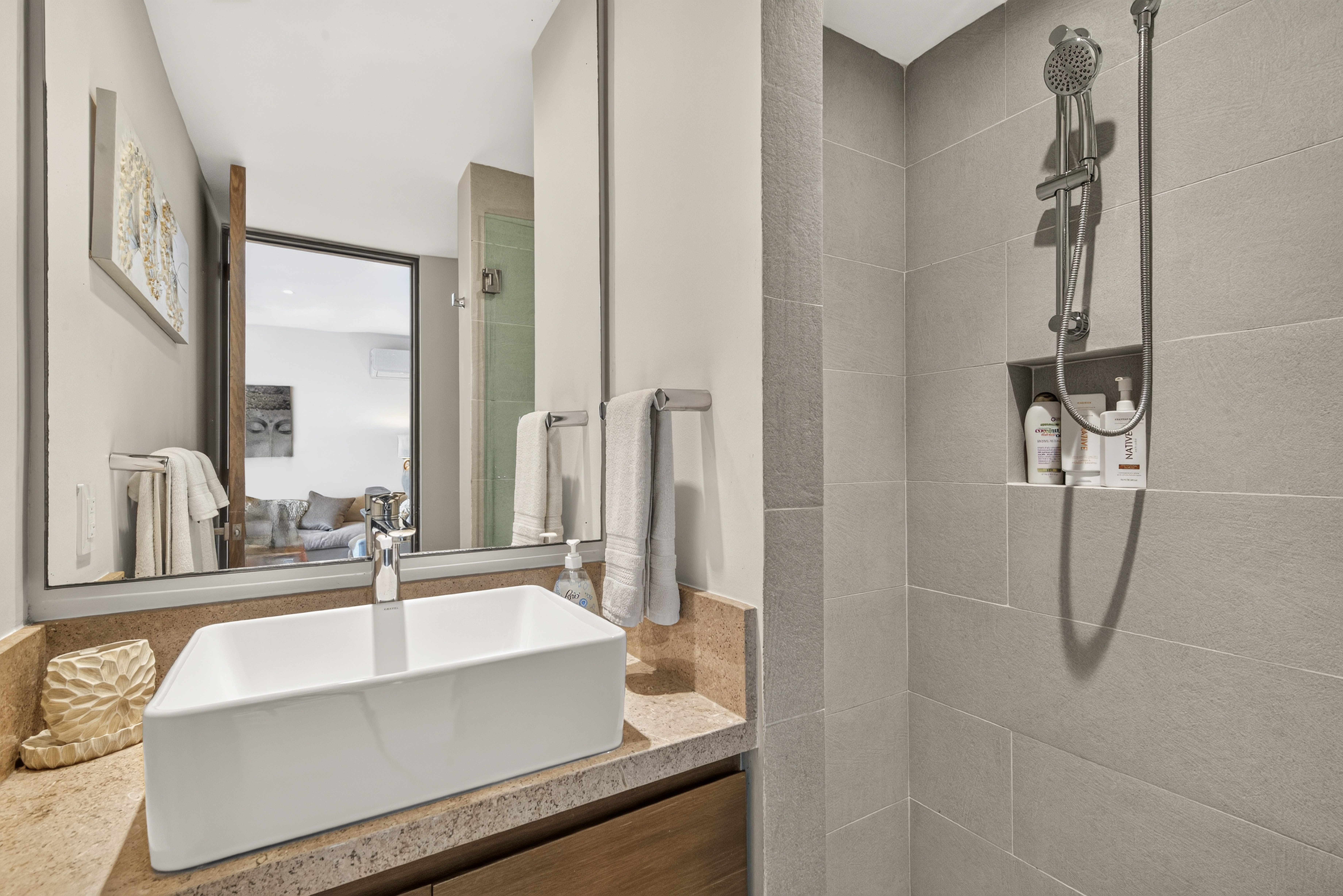 Luxury bathroom with plush towels and complimentary shampoo, conditioner, and body soap.