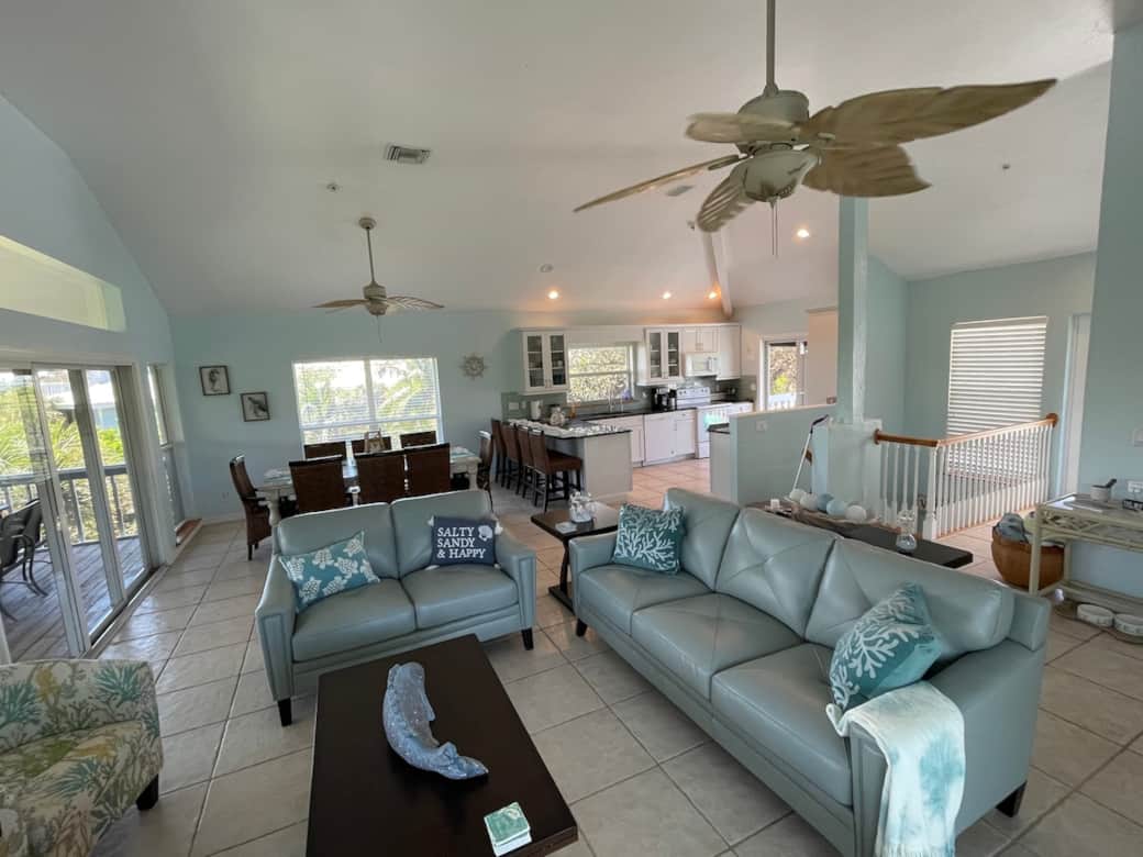 Third floor living area. Dining room and kitchen for group meals and family gatherings. Access to screened in porch and open deck and steps to crows nest. 