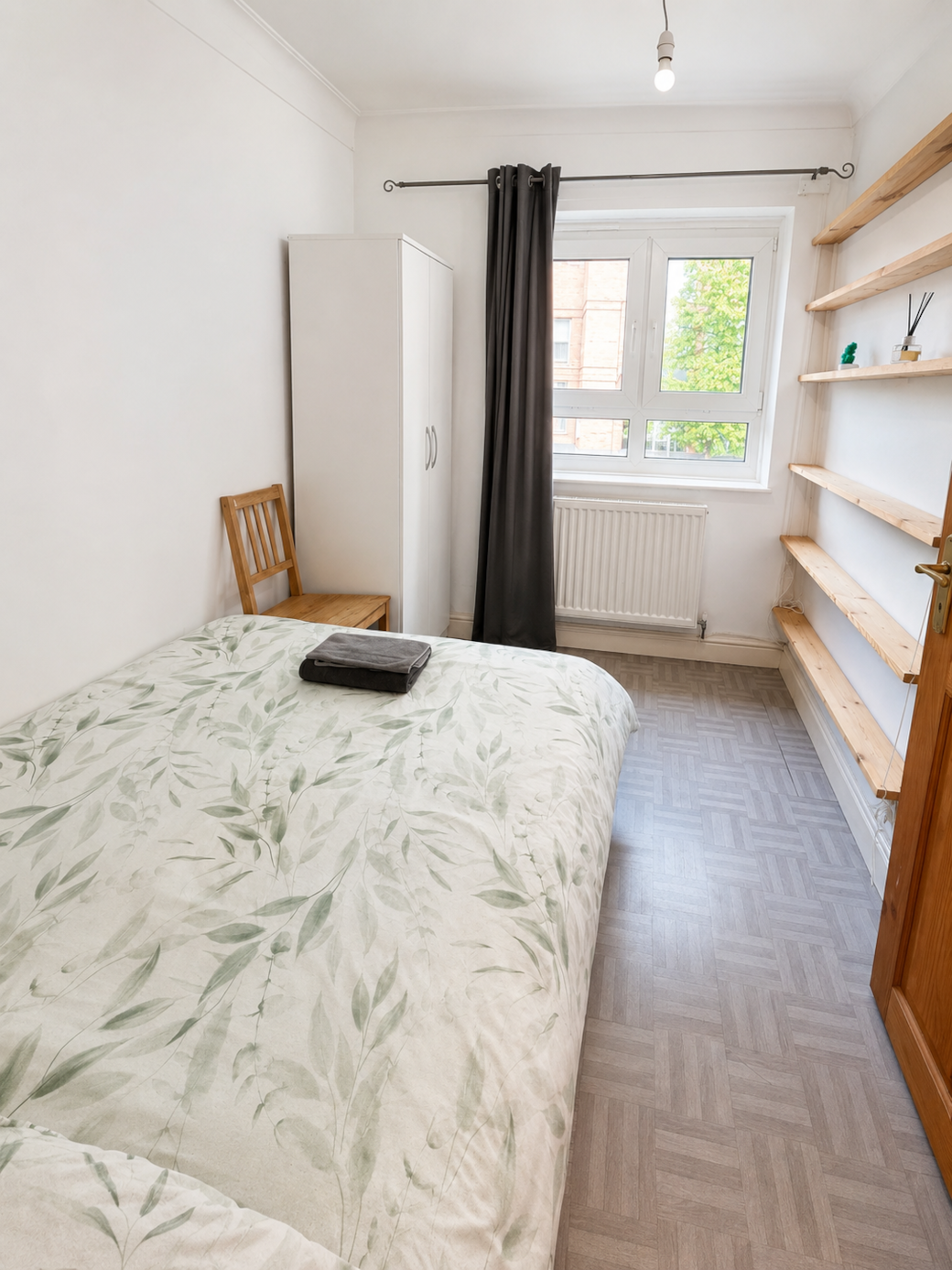 Comfortable third bedroom with wardrobe and window