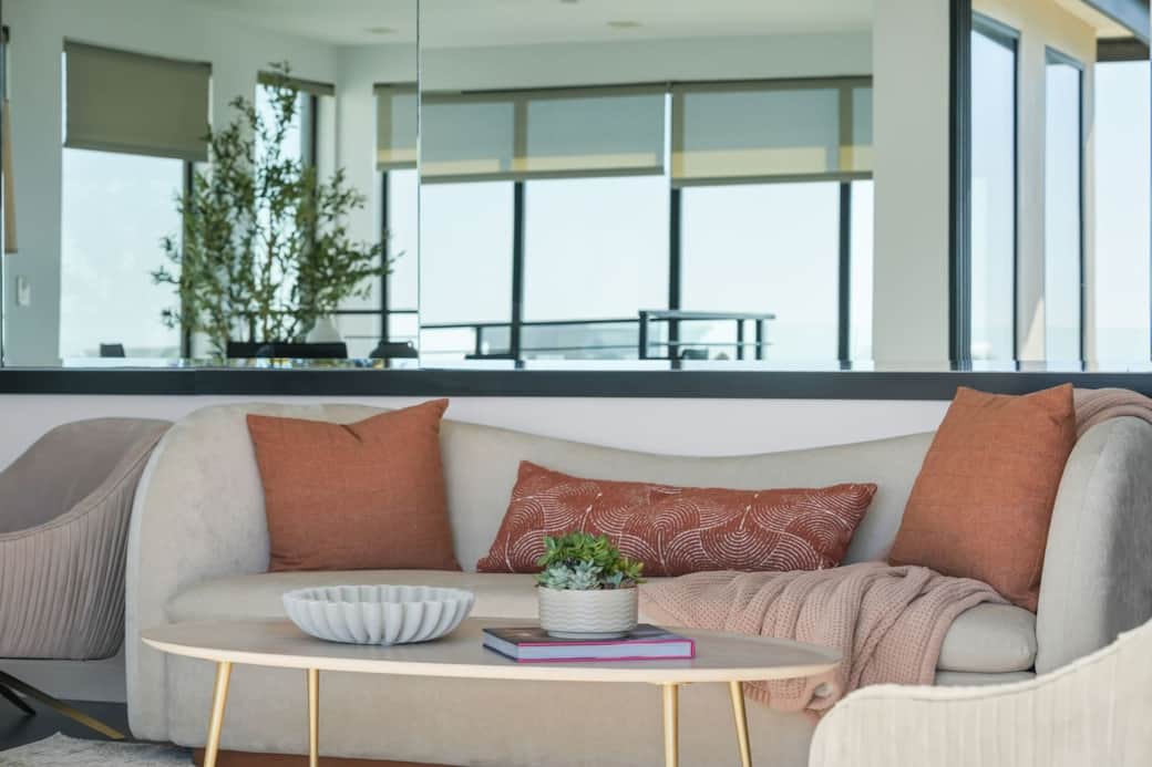 Curved sofa seating with a coffee table, creating a cozy space to unwind or gather.