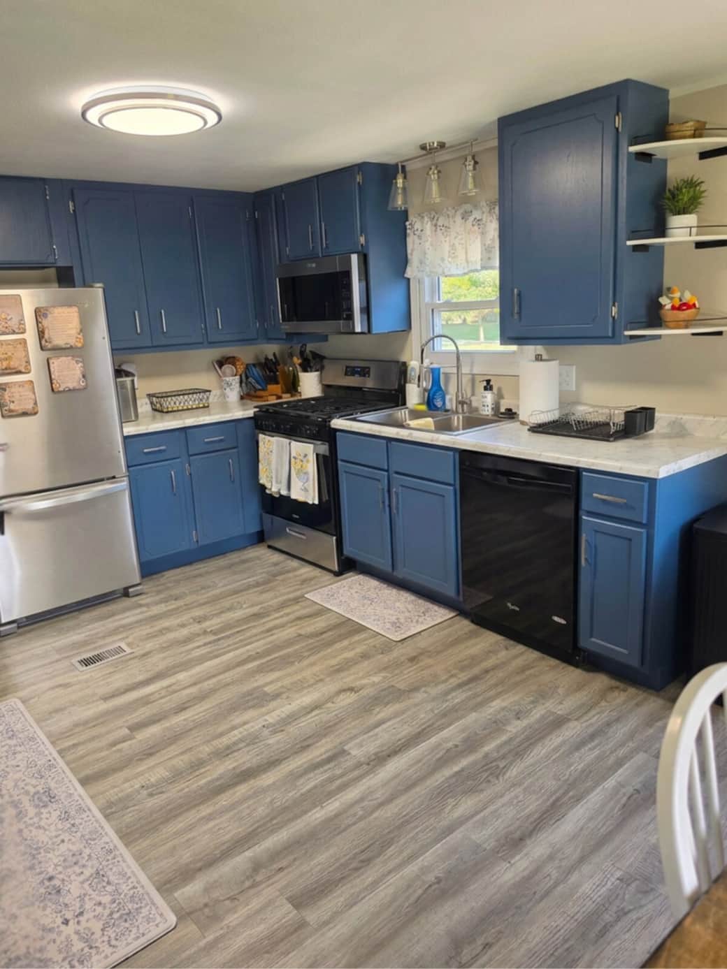 Fully functional kitchen including dishwasher, garbage disposal, range, microwave, fridge, ice maker, pots and pans, cooking essentials and dishes and glasses.