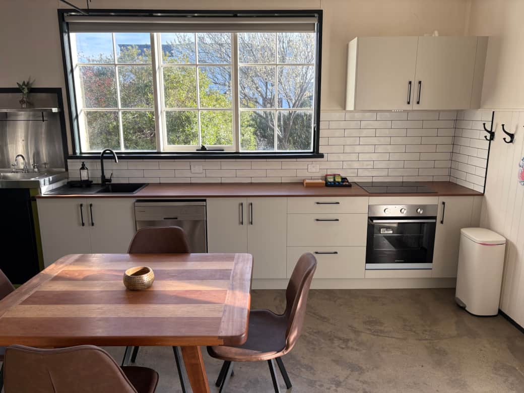 Fully equipped kitchen with oven, cooktop, dishwasher & fridge.