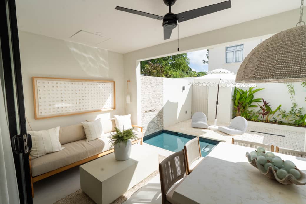 Outdoor seating and dining area overlooking the pool Outdoor seating and dining area overlooking the pool