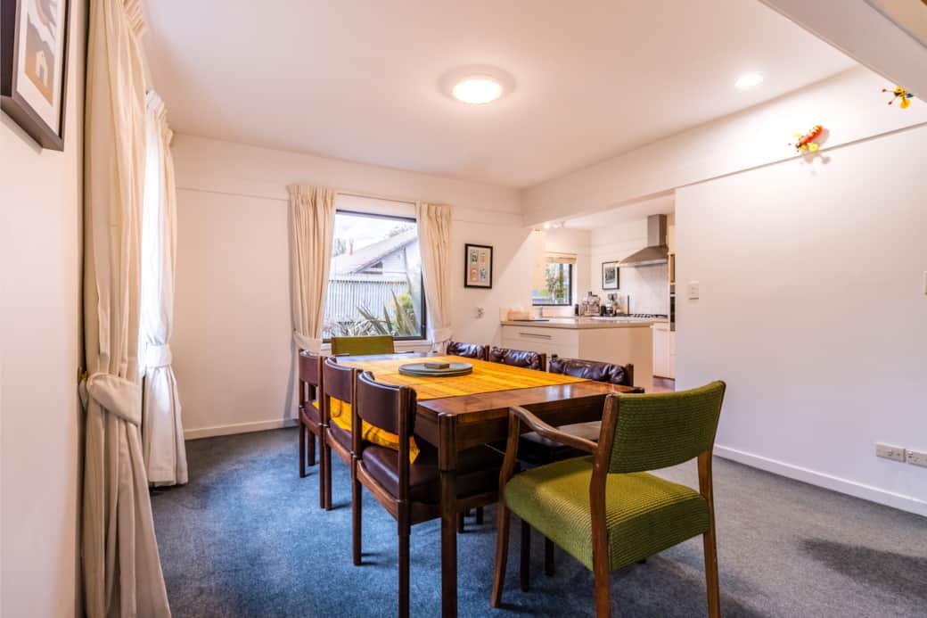 Retro dining area with rosewood table that flows seamlessly into the fully equipped kitchen.
