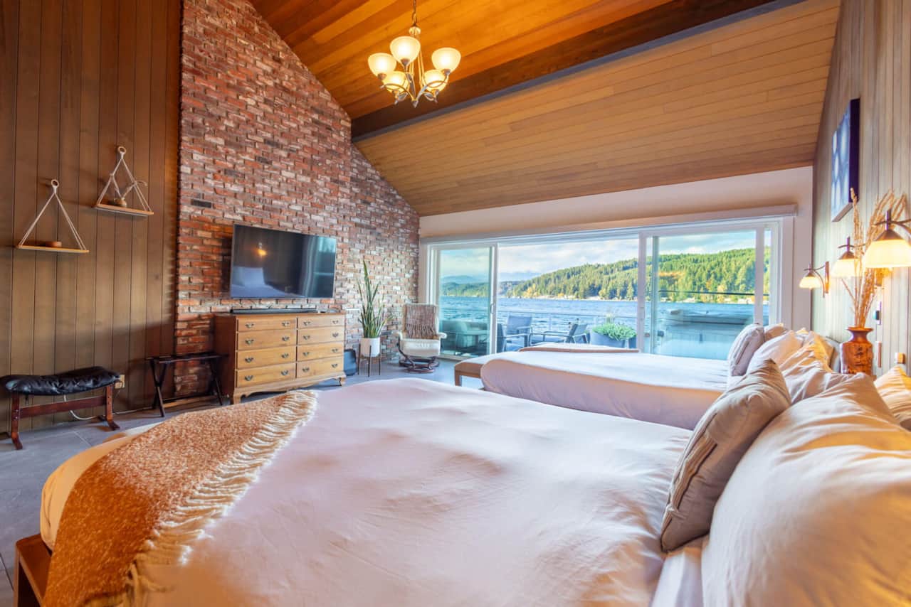 The master bedroom with comfy Tuft & Needle Cali King beds, TV, and.. hot tub right outside!