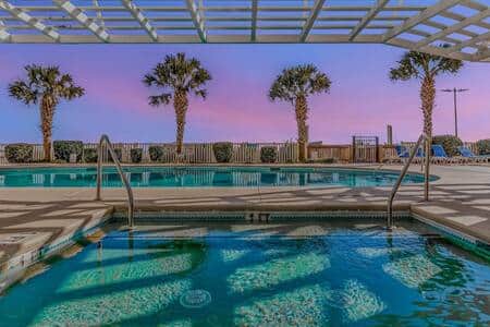 Resort kiddie pool and pool deck area at sunset.