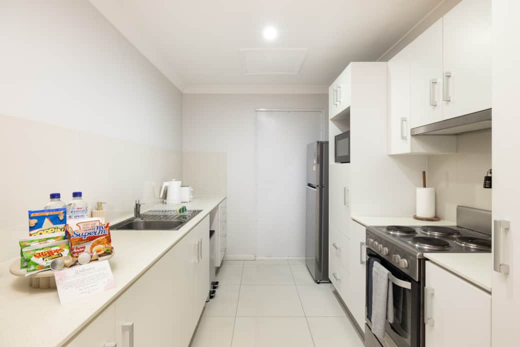 Kitchen: Sleek kitchen with ample storage, modern appliances 