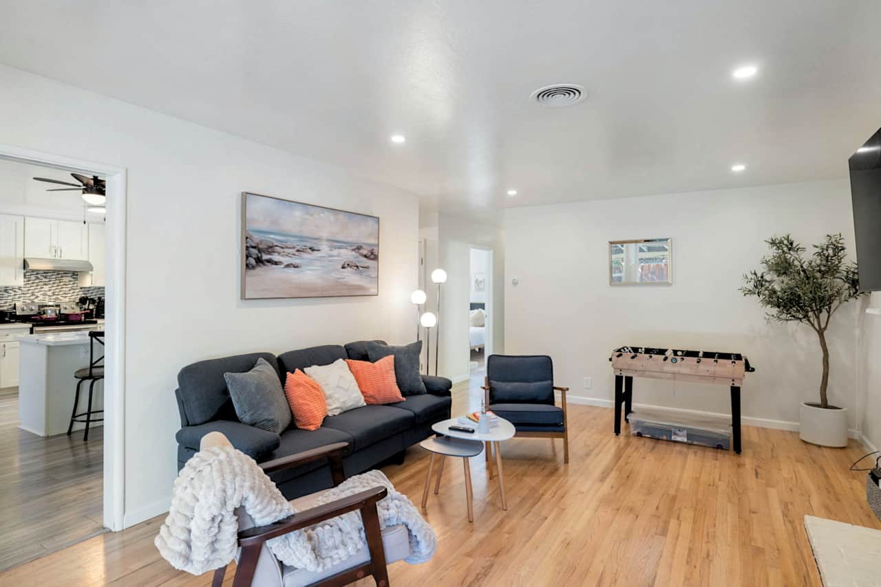 Living room view showing kitchen entrance and seating area.