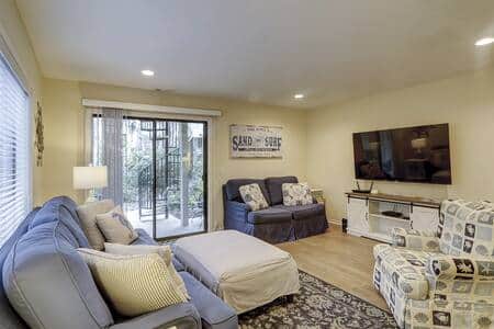 Living room with sofa, Smart TV and patio doors at 13 Beach Stop Forest Beach condo