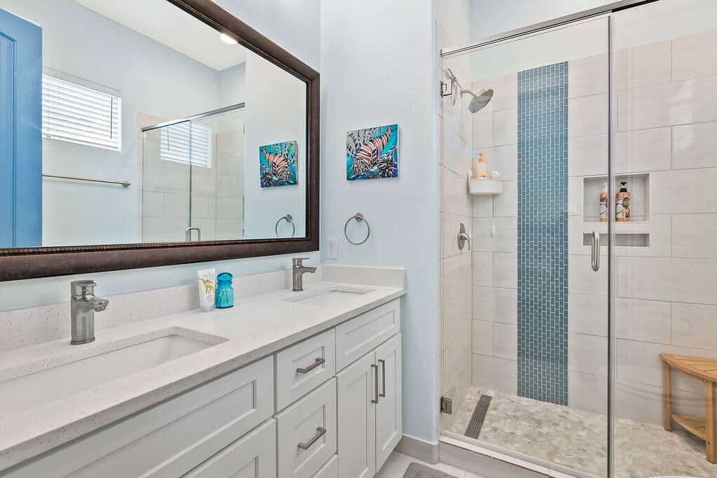 Master Bathroom with dual sinks and walk-in Shower with shower bench