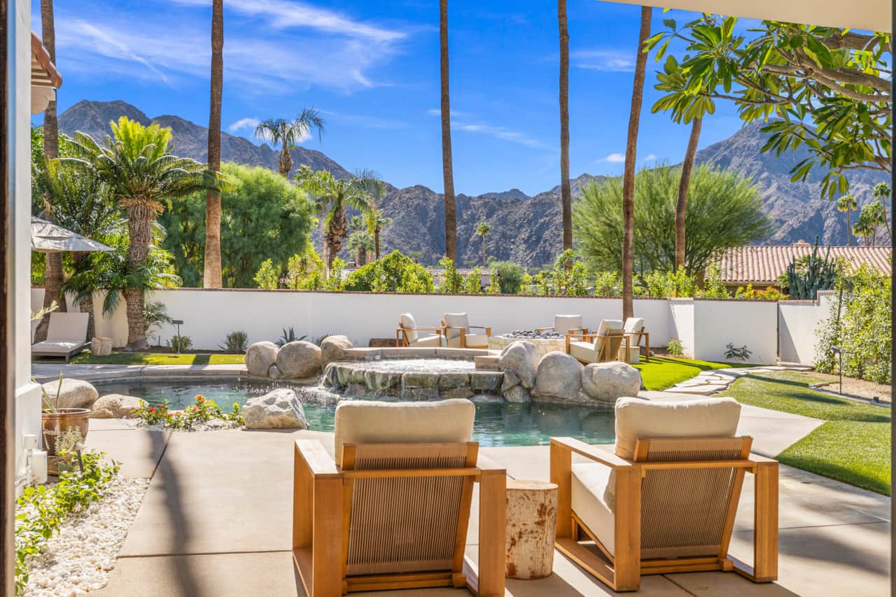 Sun-drenched afternoons unfold beside your private pool, surrounded by palms and expansive mountains