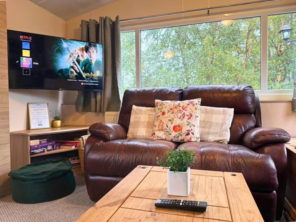 Living Room with two sofas and TV (including Netflix, Amazon Prime and Disney Plus), and dining tab