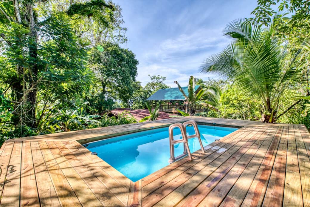 Dip into the jungle pool surrounded by lush tropical gardens — a private island getaway retreat in Bocas del Toro, Panama. Your eco lodge oasis awaits.
