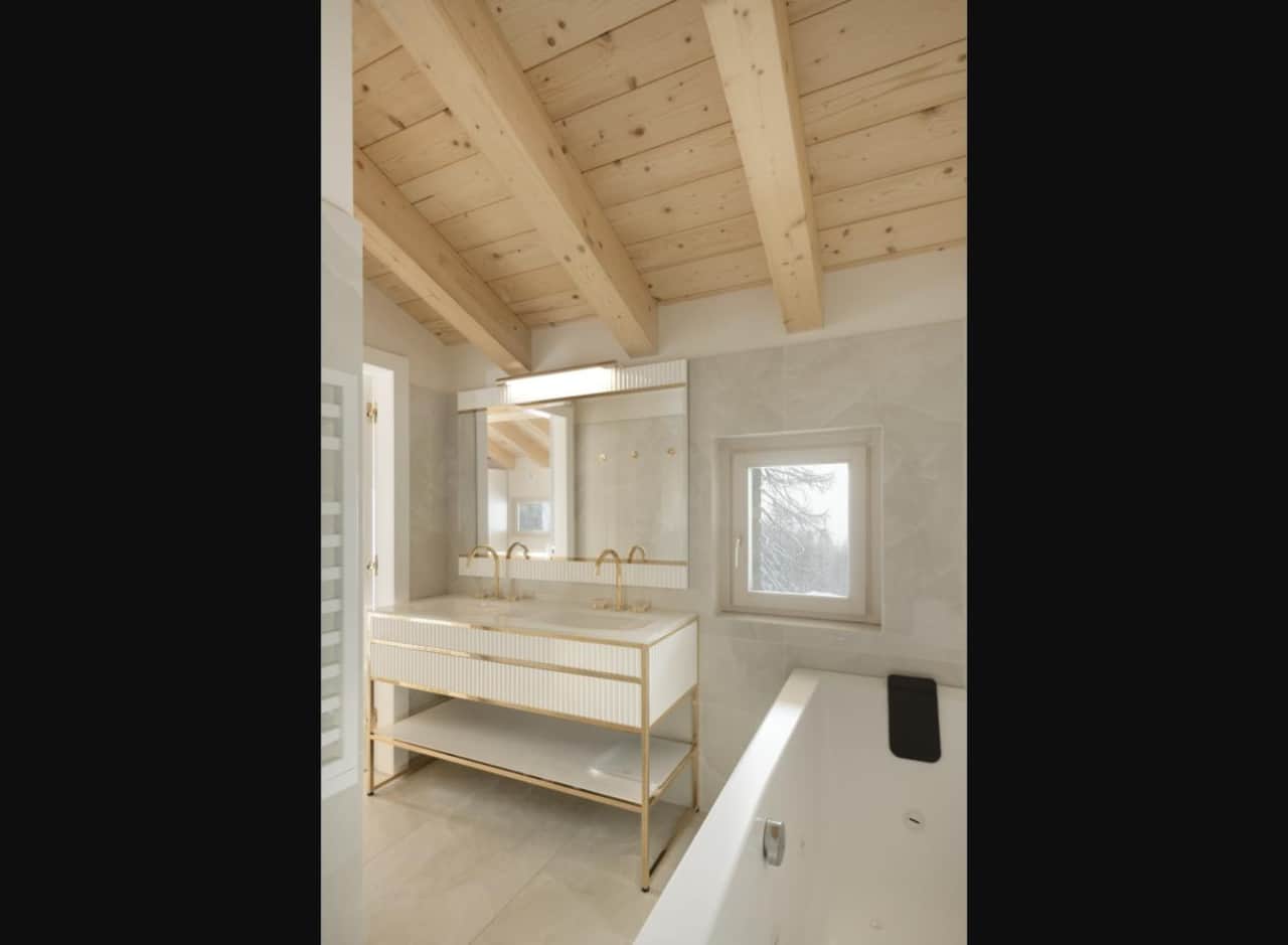 Master bathroom with bath, double vanity and window