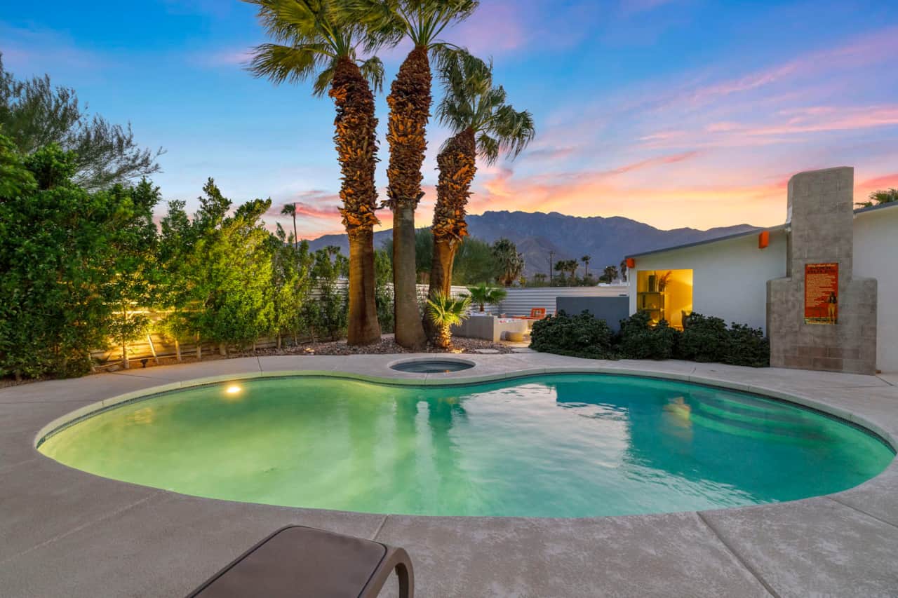 Private fenced-in resort-style backyard with pool, spa, and fire pit