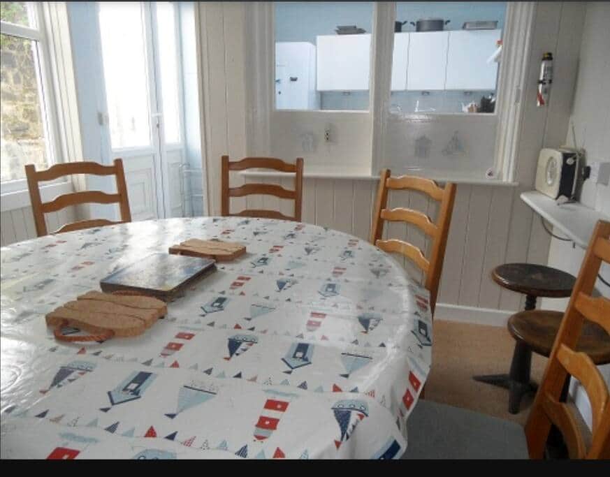 Dining room with kitchen in the distance